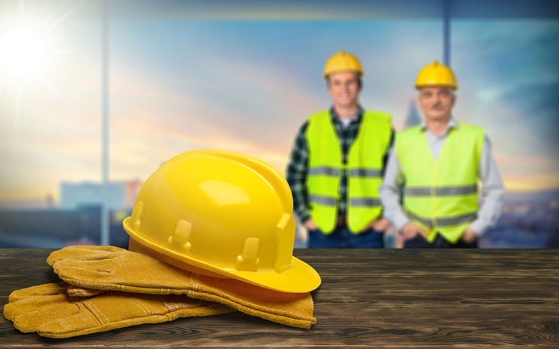 A Yellow Hard Hat Sitting on a Pair of Gloves